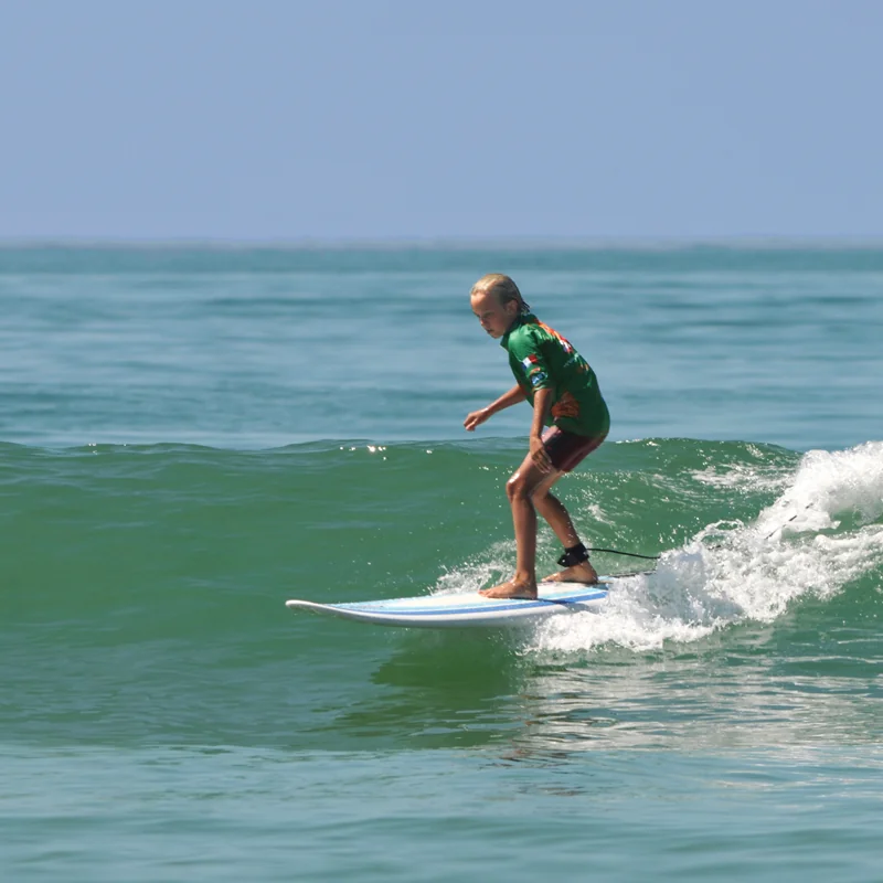 Enfant surf sur une vague cours de surf Côte Sauvage La Palmyre – ESCS La Palmyre Côte Sauvage