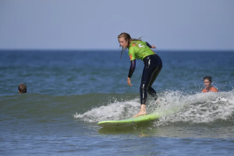 Jeune fille surf sur une vague Côte Sauvage La Palmyre – ESCS La Palmyre Côte Sauvage